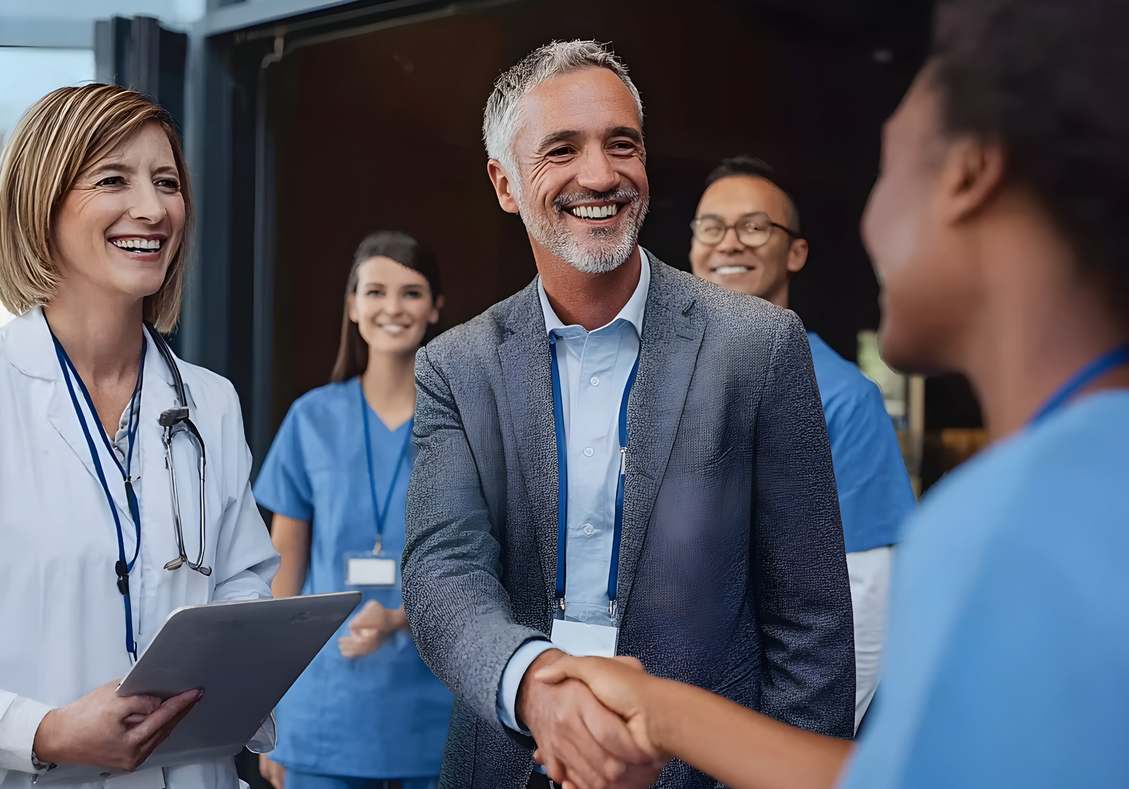 Healthcare leadership team shaking hands in partnership